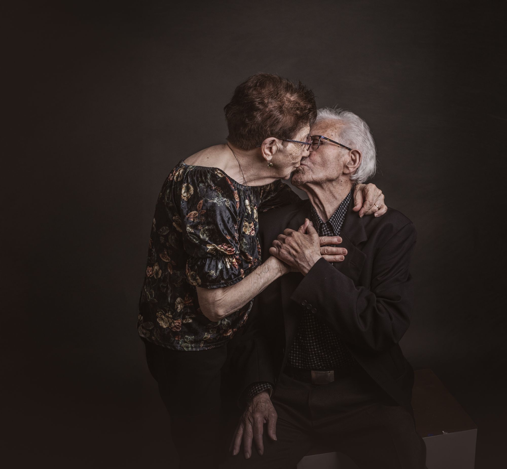 Abuelos dándose un beso en el estudio
